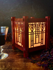 Wooden lantern with geometric Frank Lloyd Wright pattern on a dark background